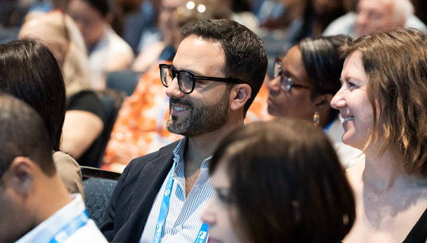 People smiling in the audience of the Retail Days sessions