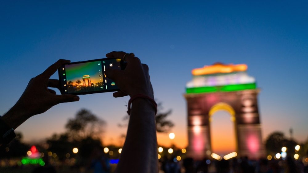 someone taking a photo of the city gate