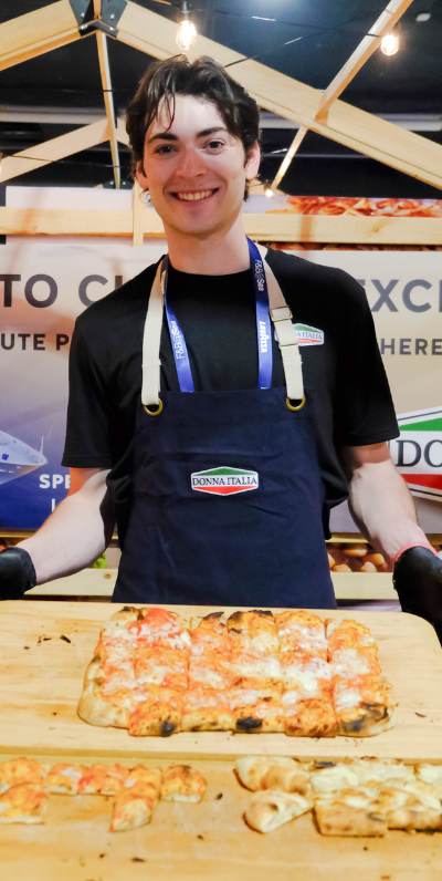 Person pouring drink into a martini glass